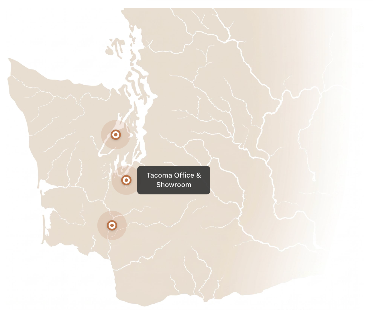 Map with three location pins and a label for “Tacoma Office & Showroom” on a beige background