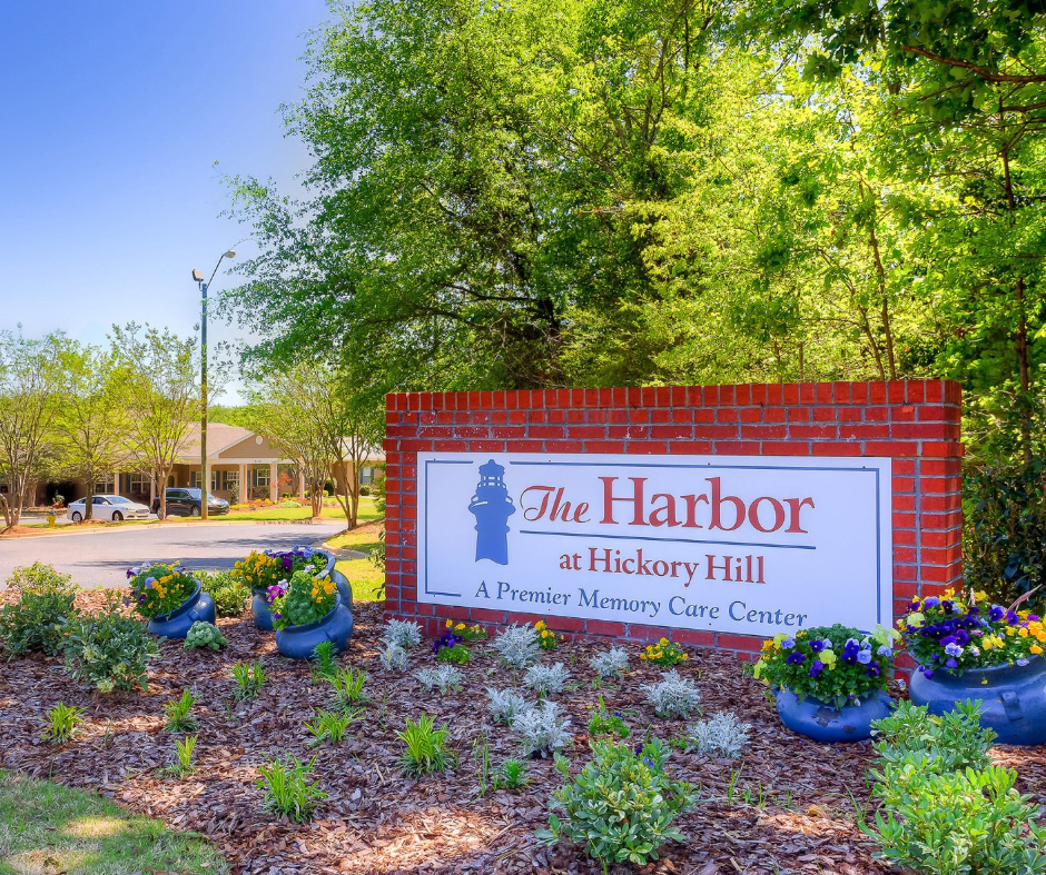 A sign for the harbor sits on a brick wall