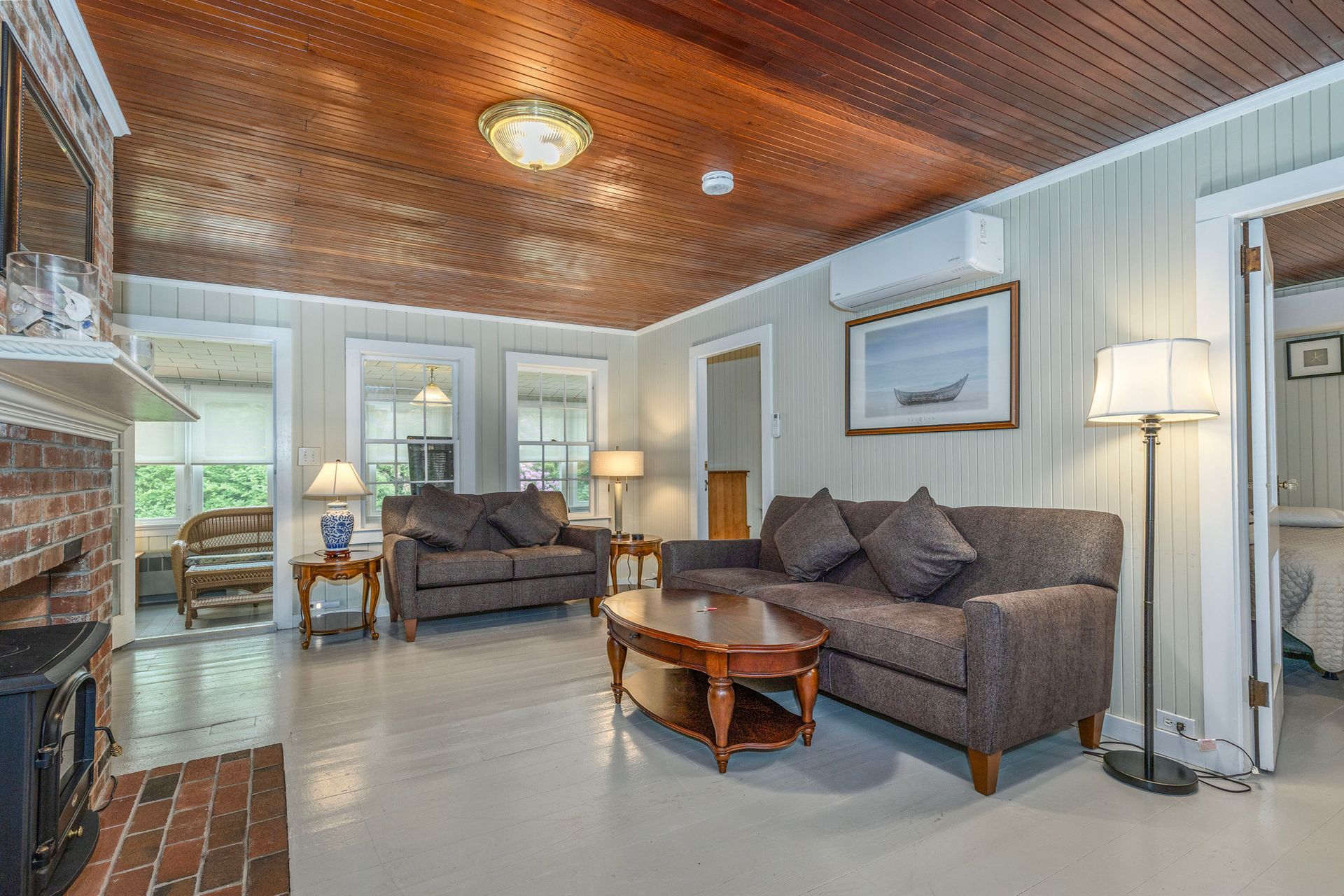 A living room with two couches , a coffee table , and a fireplace.