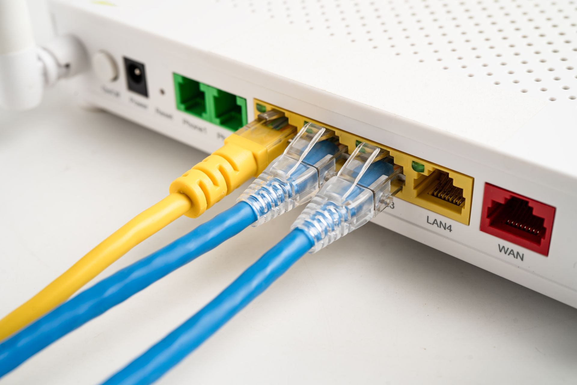 Server rack with orange fiber optic cables lit up.