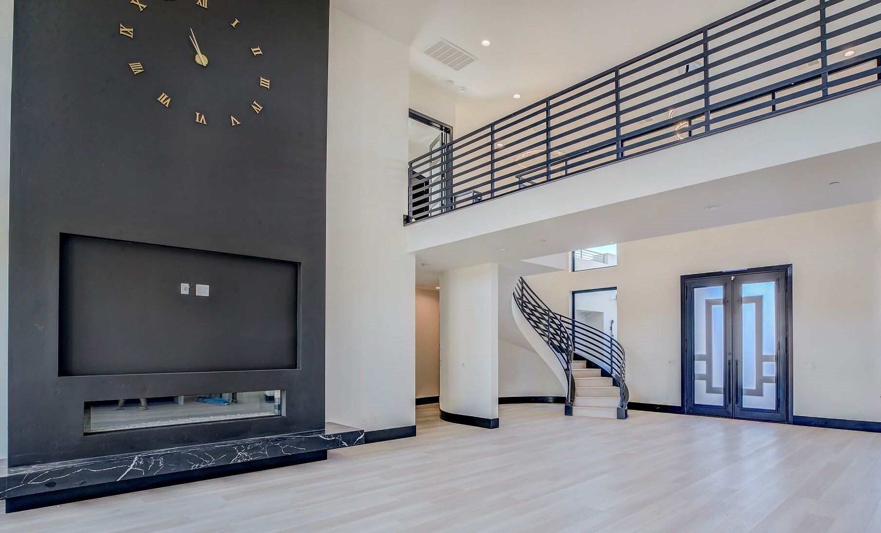 Great room with a linear fireplace and high ceilings