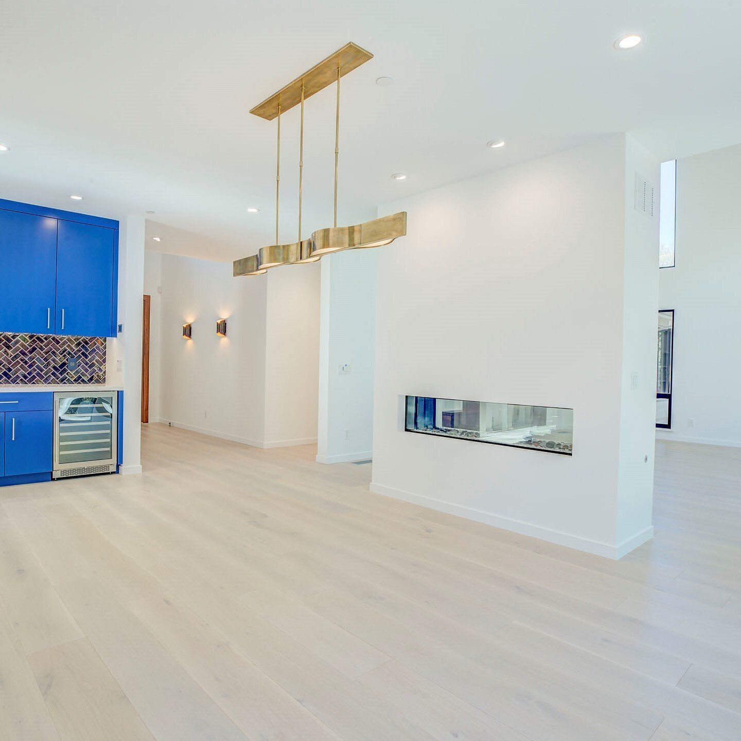 white painted wall dividing the living room and kitchen area