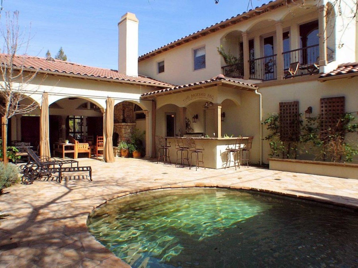 contemporary pool area of house with mini bar