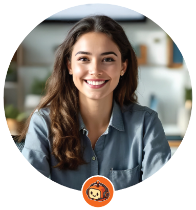 Smiling woman in blue shirt, sitting indoors.  Orange logo in the lower corner.