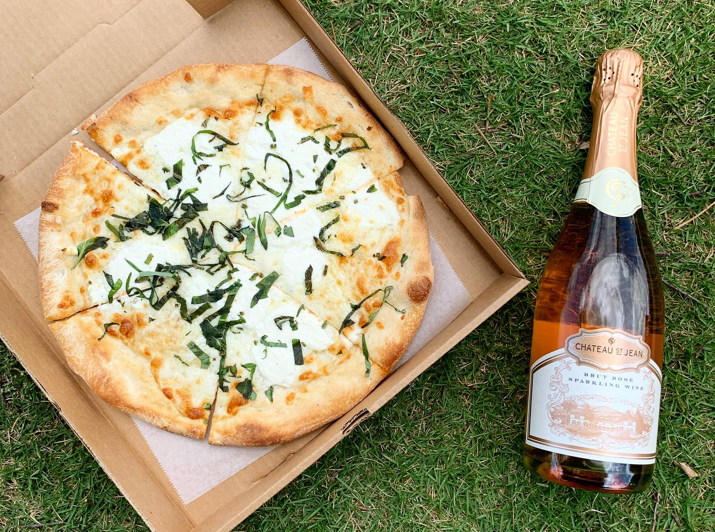 fresh pizza in a box with wine fresh pizza in a box with wine
