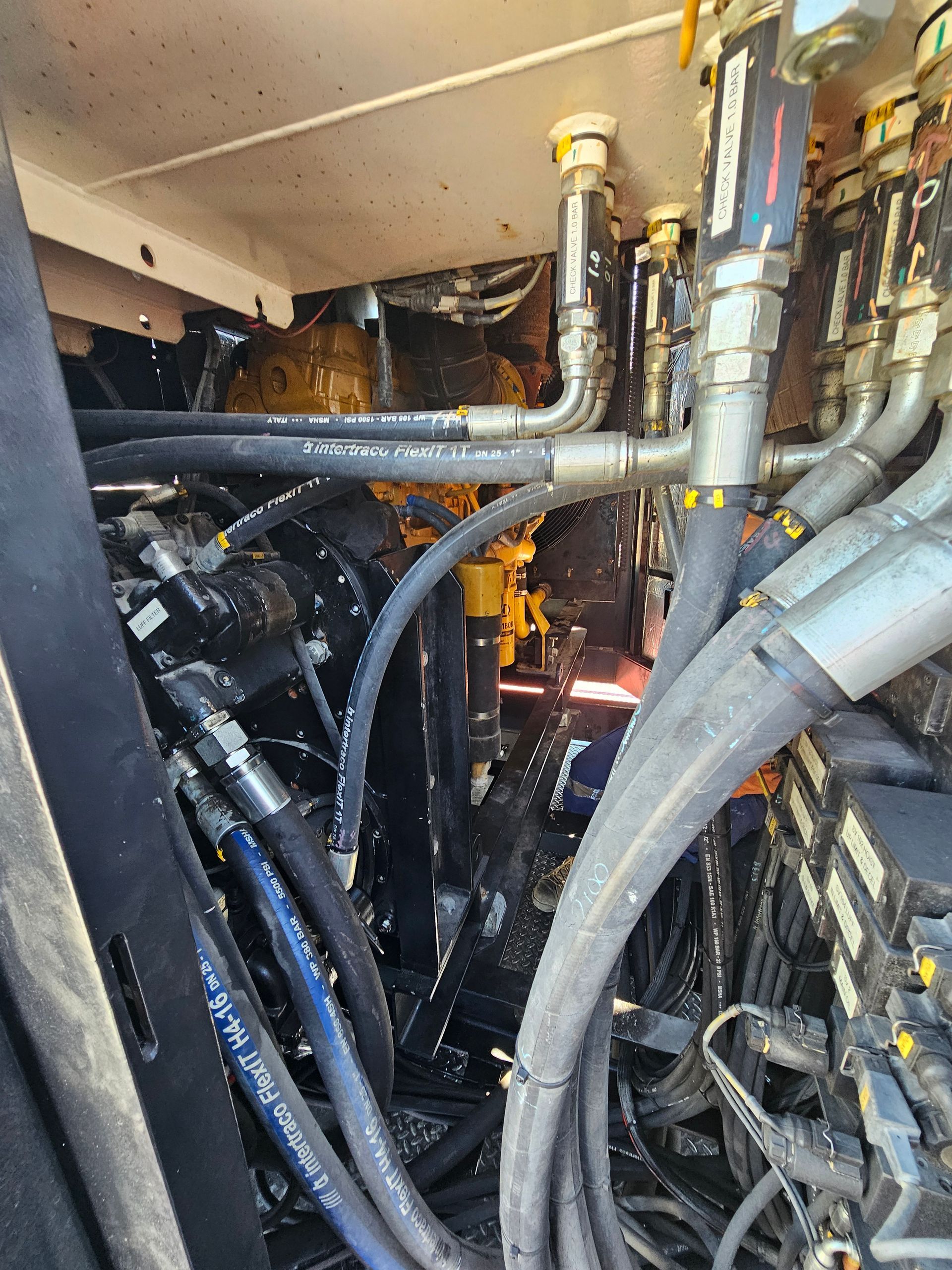 Close-up of tower crane machinery, hydraulic hoses and mechanical components