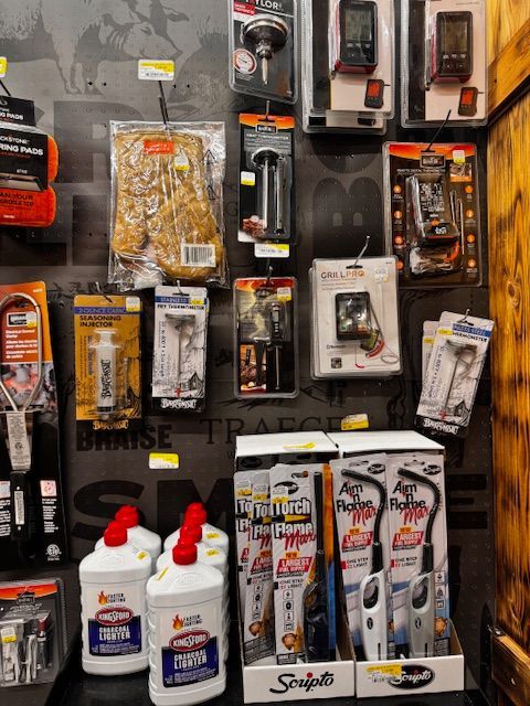 Assorted hardware tools and supplies displayed on a retail pegboard, with glue bottles and packaged accessories.