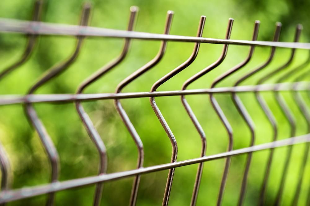 a Close Up of a Wire Fence With a Green Background — Tony Sinclair Fencing In Bellingen, NSW 

