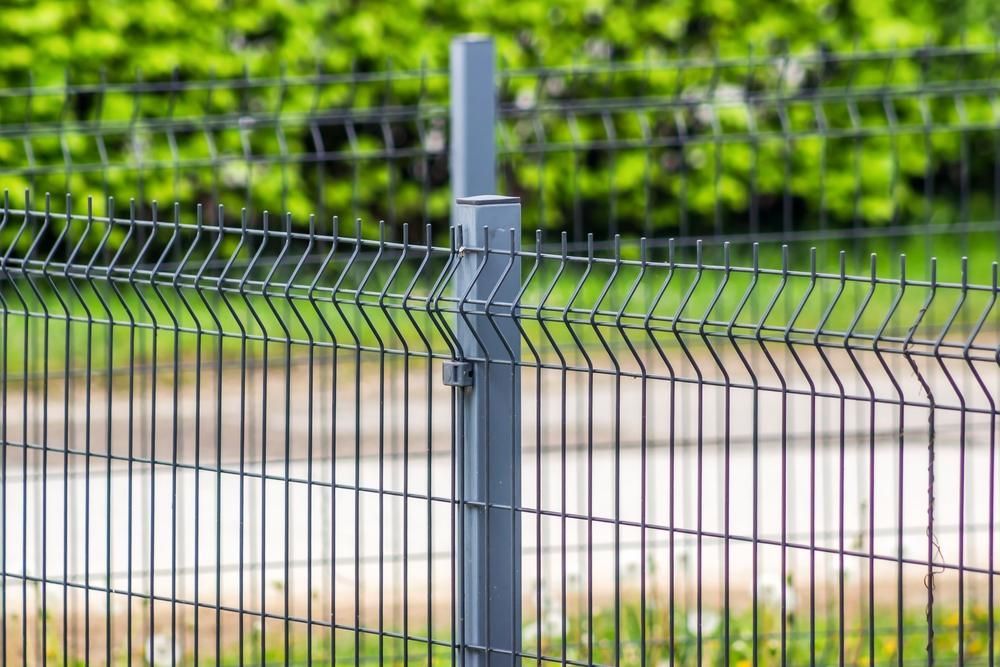 a Close Up of a Metal Fence With a Post in the Middle of It — Tony Sinclair Fencing In Bucca, NSW