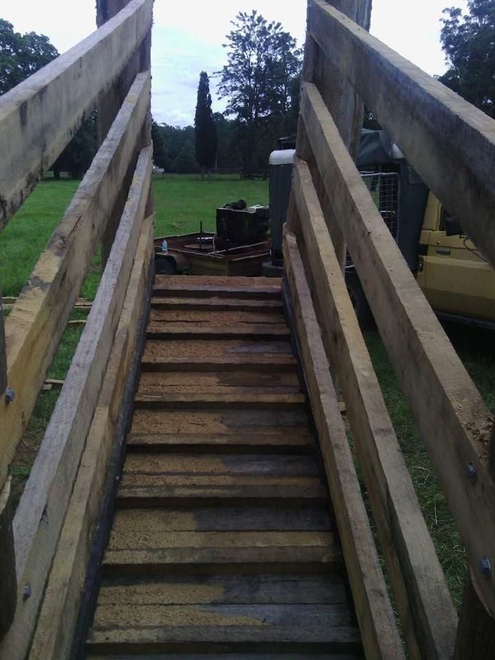 a Wooden Ramp Leading to a Grassy Field — Tony Sinclair Fencing In Bucca, NSW