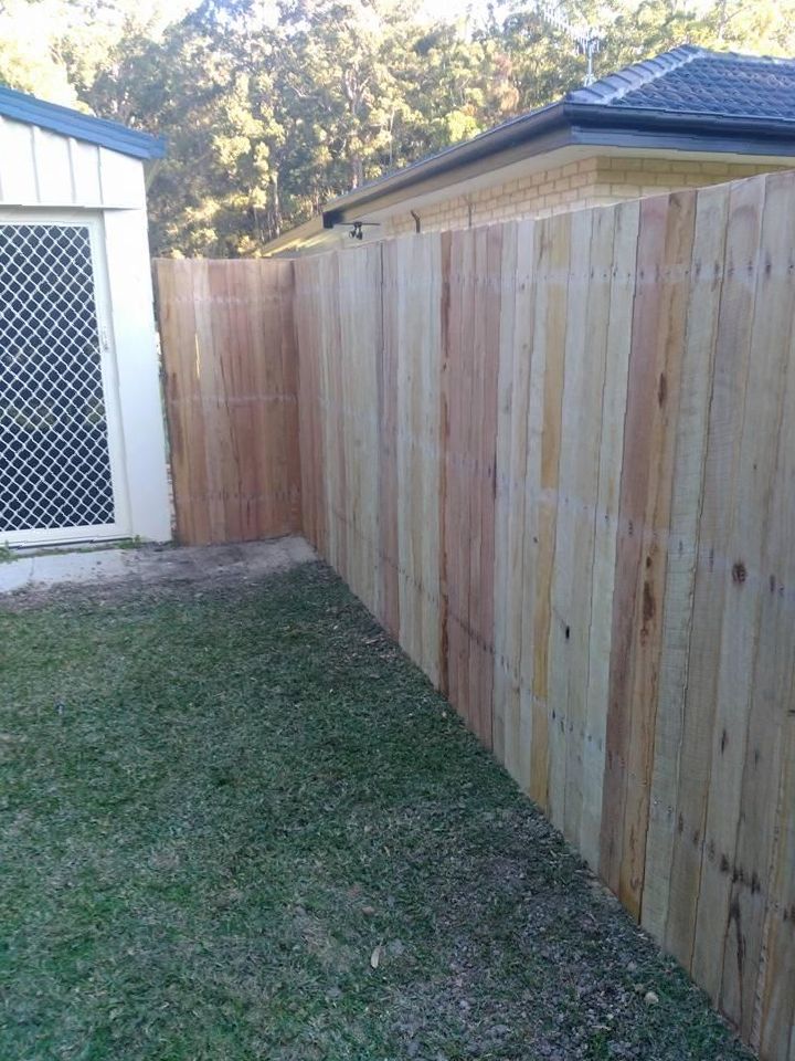 a Wooden Fence is in the Backyard of a House — Tony Sinclair Fencing In Bucca, NSW