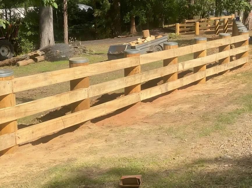 a Wooden Fence is Being Built in a Yard — Tony Sinclair Fencing In Coffs Harbour, NSW
