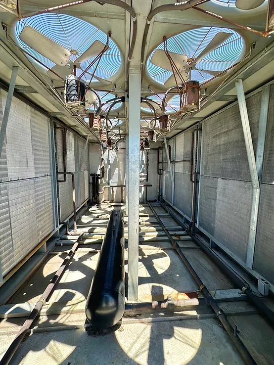 The inside of a building with a lot of fans on the ceiling.