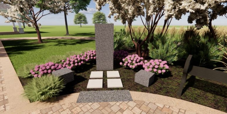Memorial stone in a landscaped garden with pink flowers and paved walkway