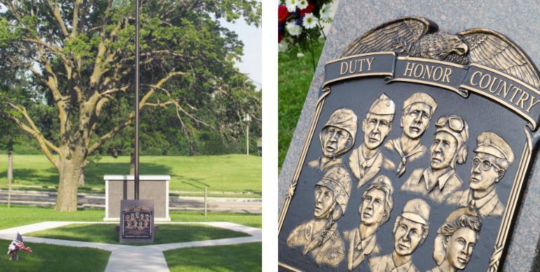 Memorial stone in a park with engraved faces and the words “Honor Country,” beside a tree-lined lawn