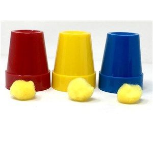 A red , yellow , and blue cup with yellow pom poms inside of them.