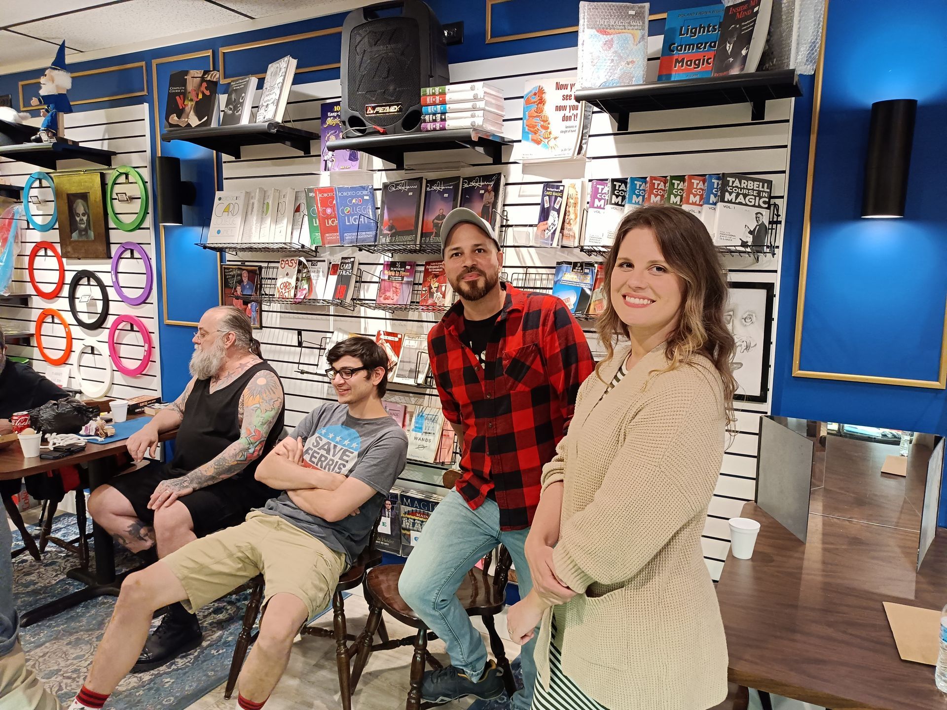 A group of people are standing around a table in a store.