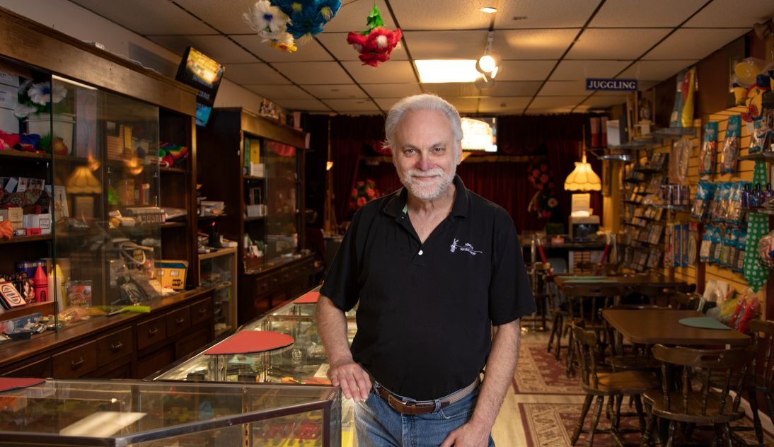 A man in a black shirt is standing in a store.