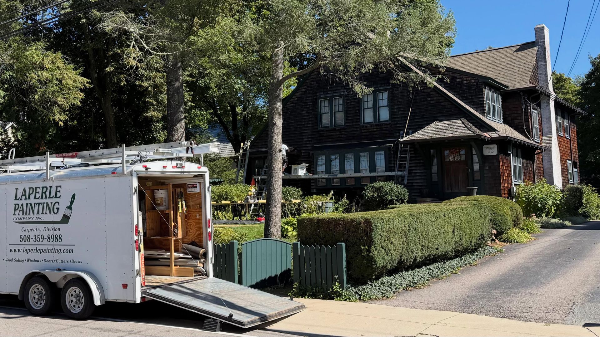 Laperle Painting Carpentry Division trailer parked outside a historic 1910 home during repairs in Medfield, MA