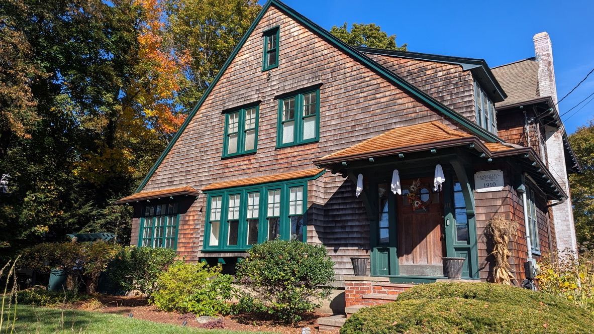 Restored entry and window roofs with new cedar shingles on the Granville C. Mitchell House, Medfield, MA