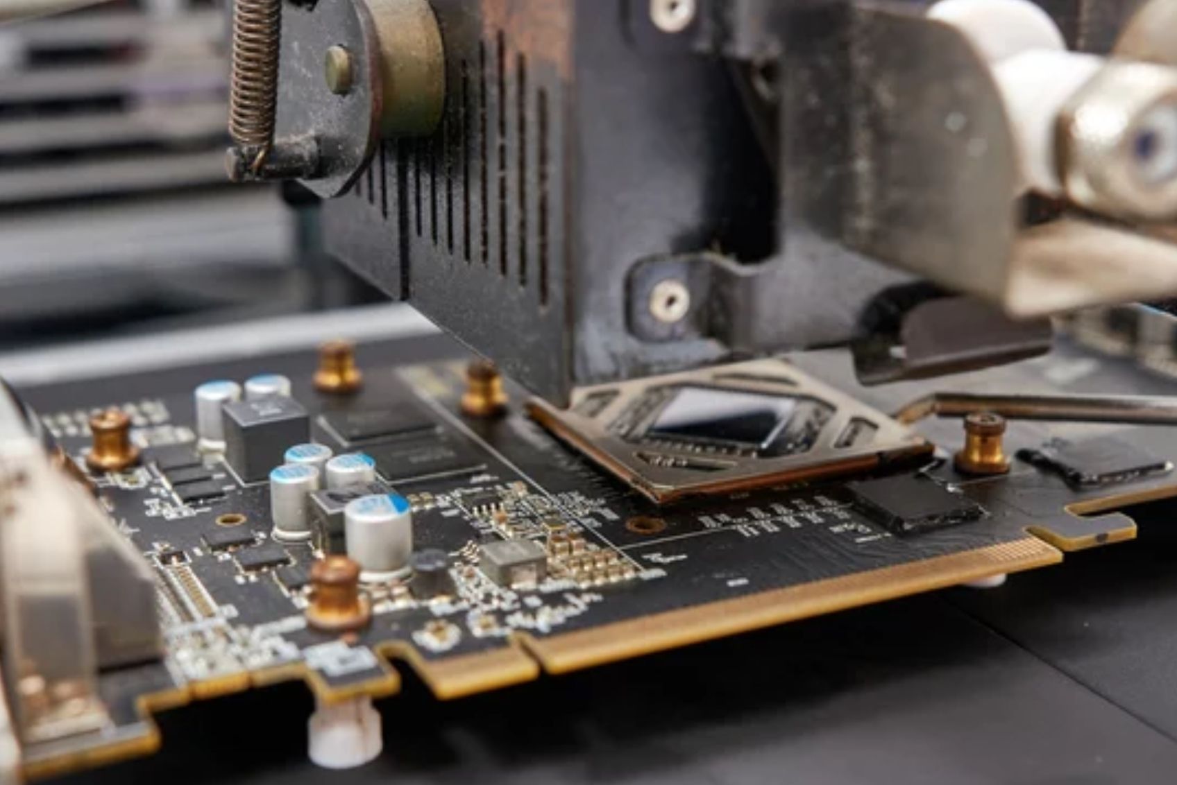 CPU and CPU fan lifted above a motherboard