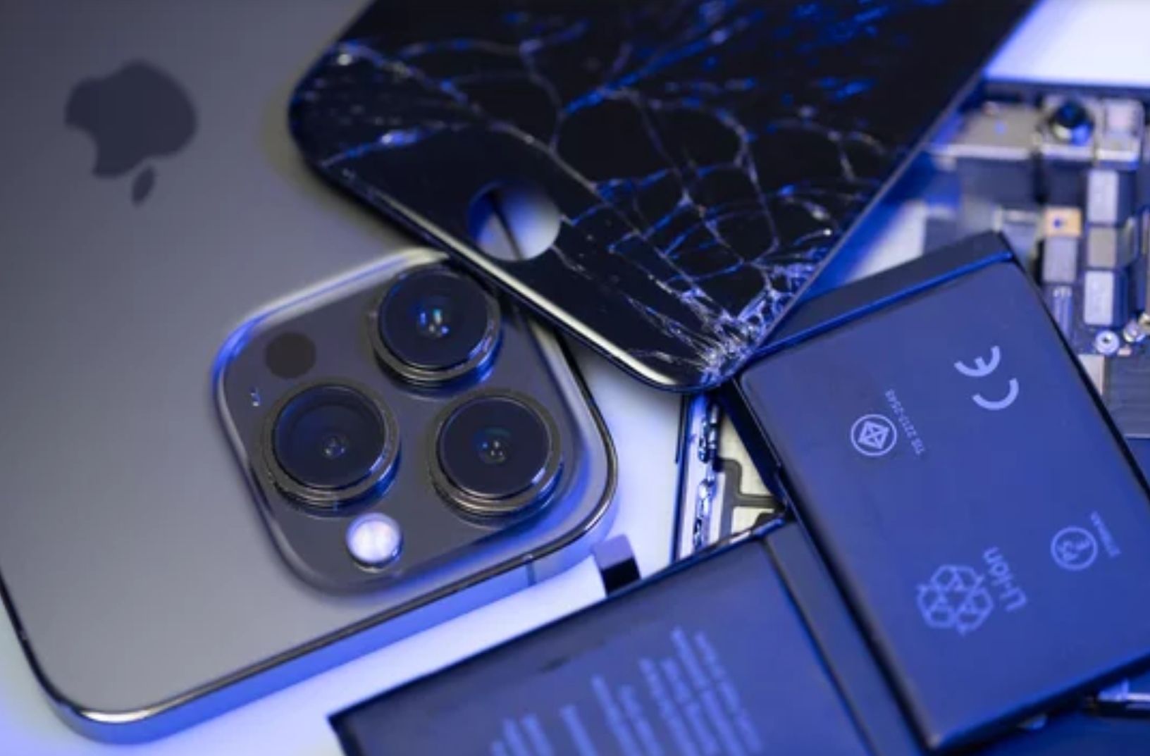 A mobile phone with a broken screen to one side