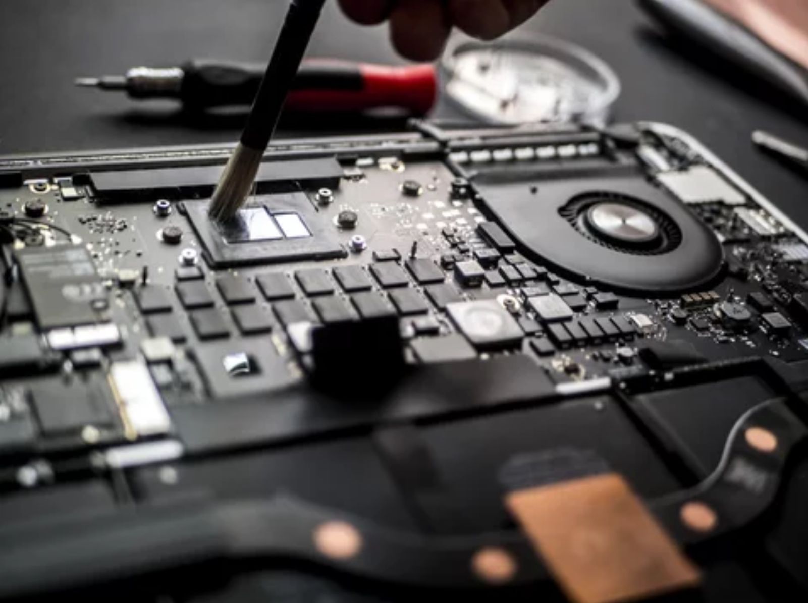 Laptop circuit board being cleaned