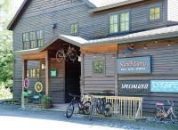 Bike shop exterior with wooden siding, sign reads