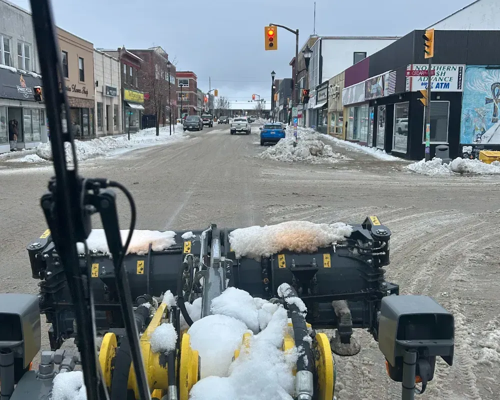 clearing snow from downtown street in Timmins