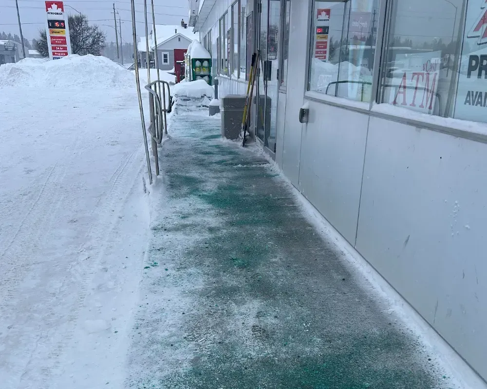 shoveled and ice melter applied to sidewalk around convenience store in timmins on