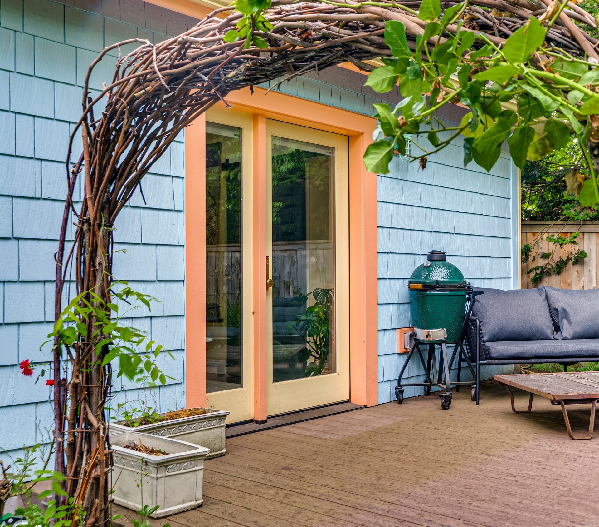 A happy color scheme of sky blue, persimmon and curry yellow on the exterior of the garage-turned-studio.