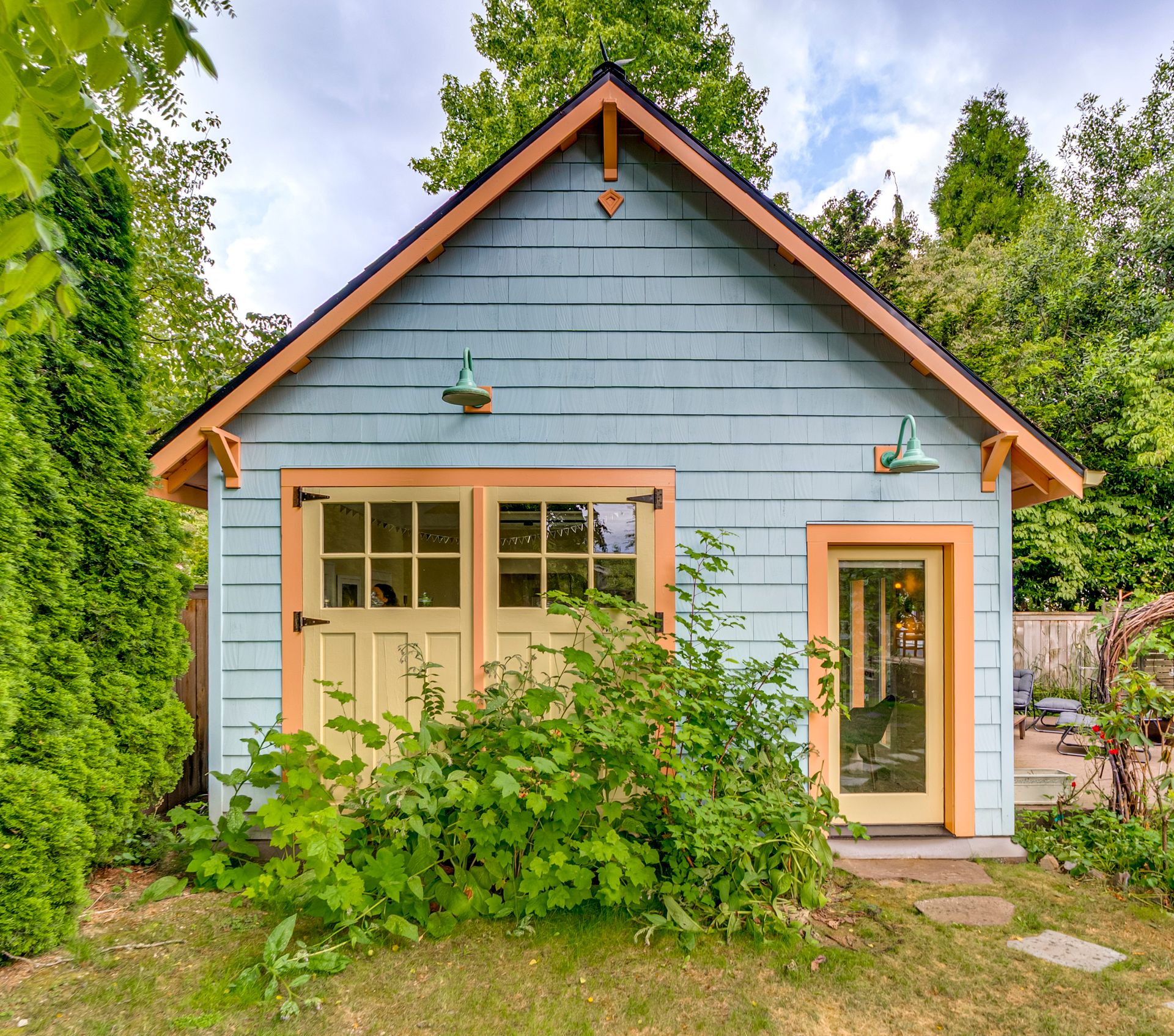 The restored garage-turned-studio, in persimmon, curry yellow and sky blue.