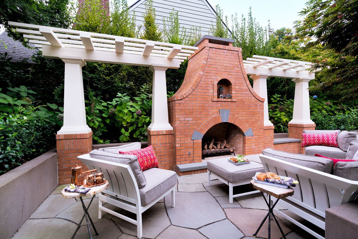 Alongside the driveway is an alluring outdoor living room with fireplace and trellis, mini garden and bee hives.