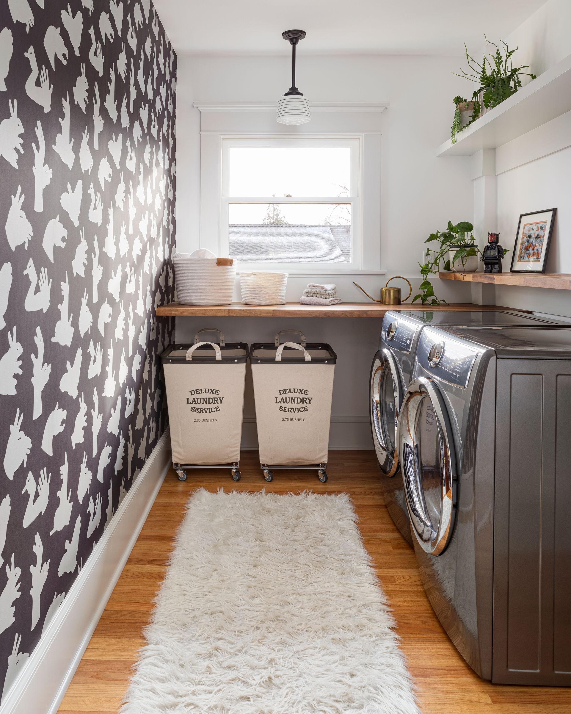 A new 2nd floor laundry room within a former bedroom features shadow puppet wallpaper.