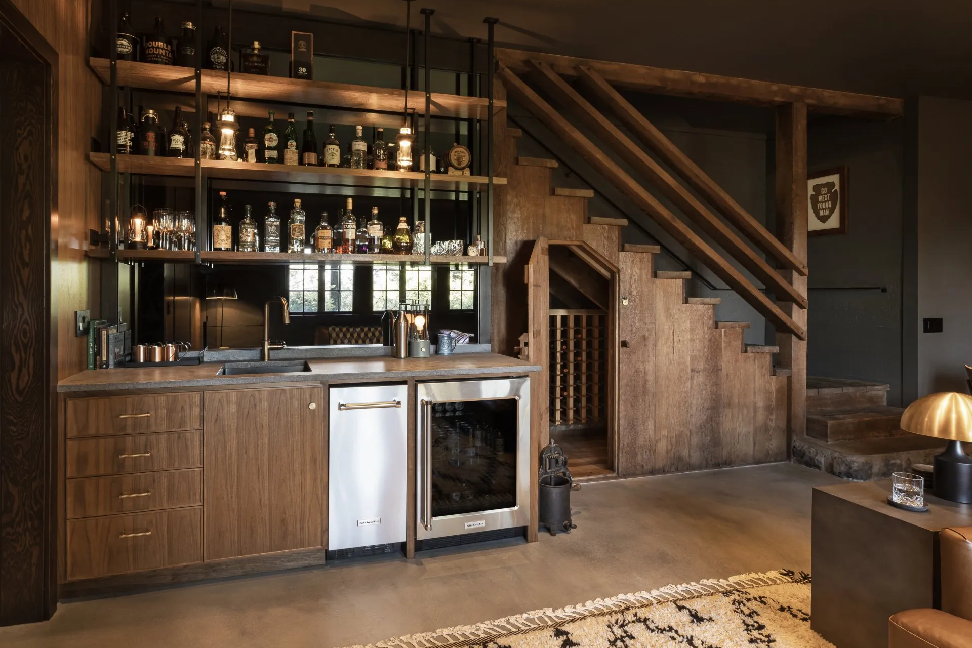 In this Columbia Gorge Tudor, rich wood paneling and millwork embrace the basement’s natural darkness, while focused lighting at the bar brings warmth and depth to the room.