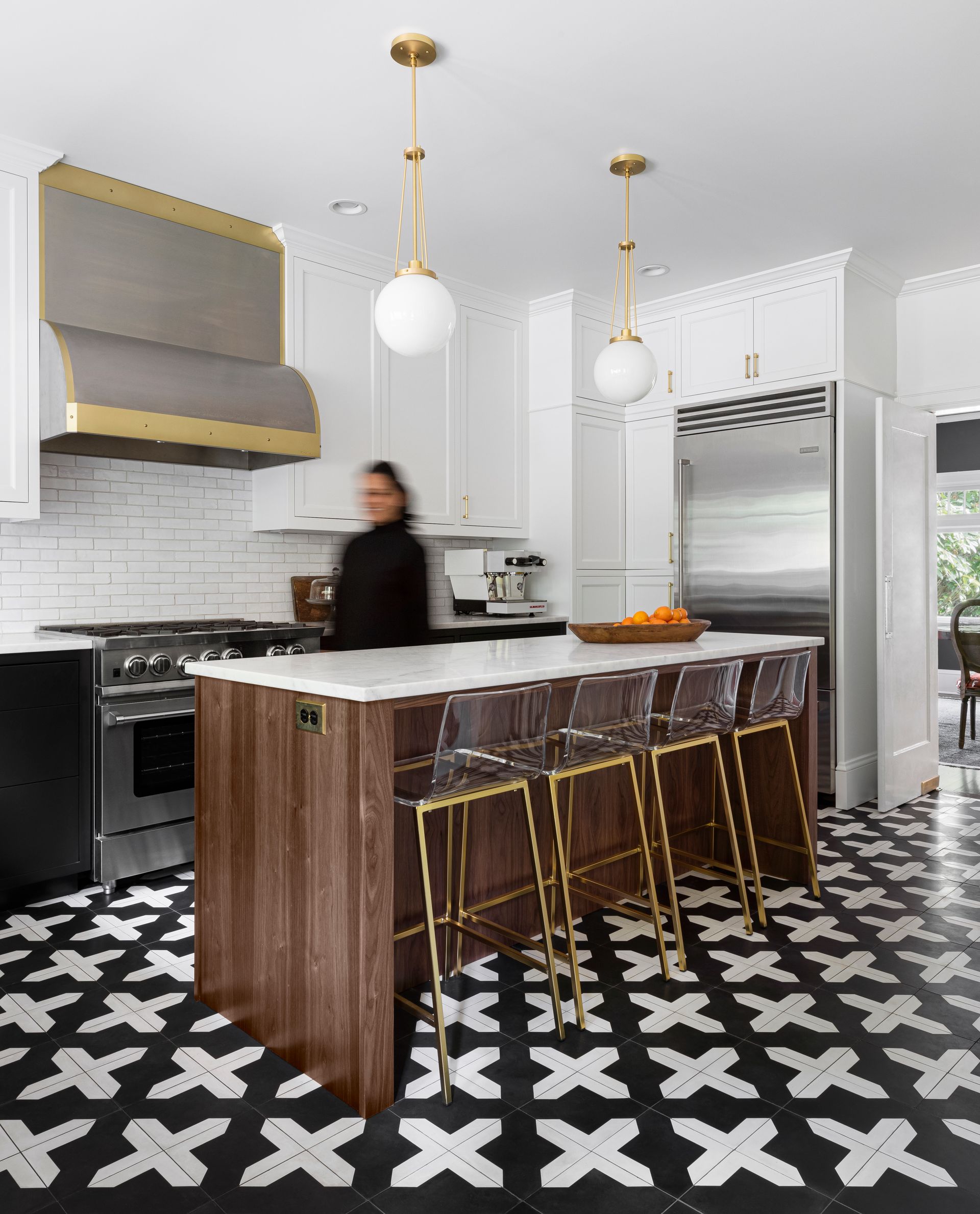 Arciform cabinets and island frame a beautiful, timeless palette in this striking kitchen.