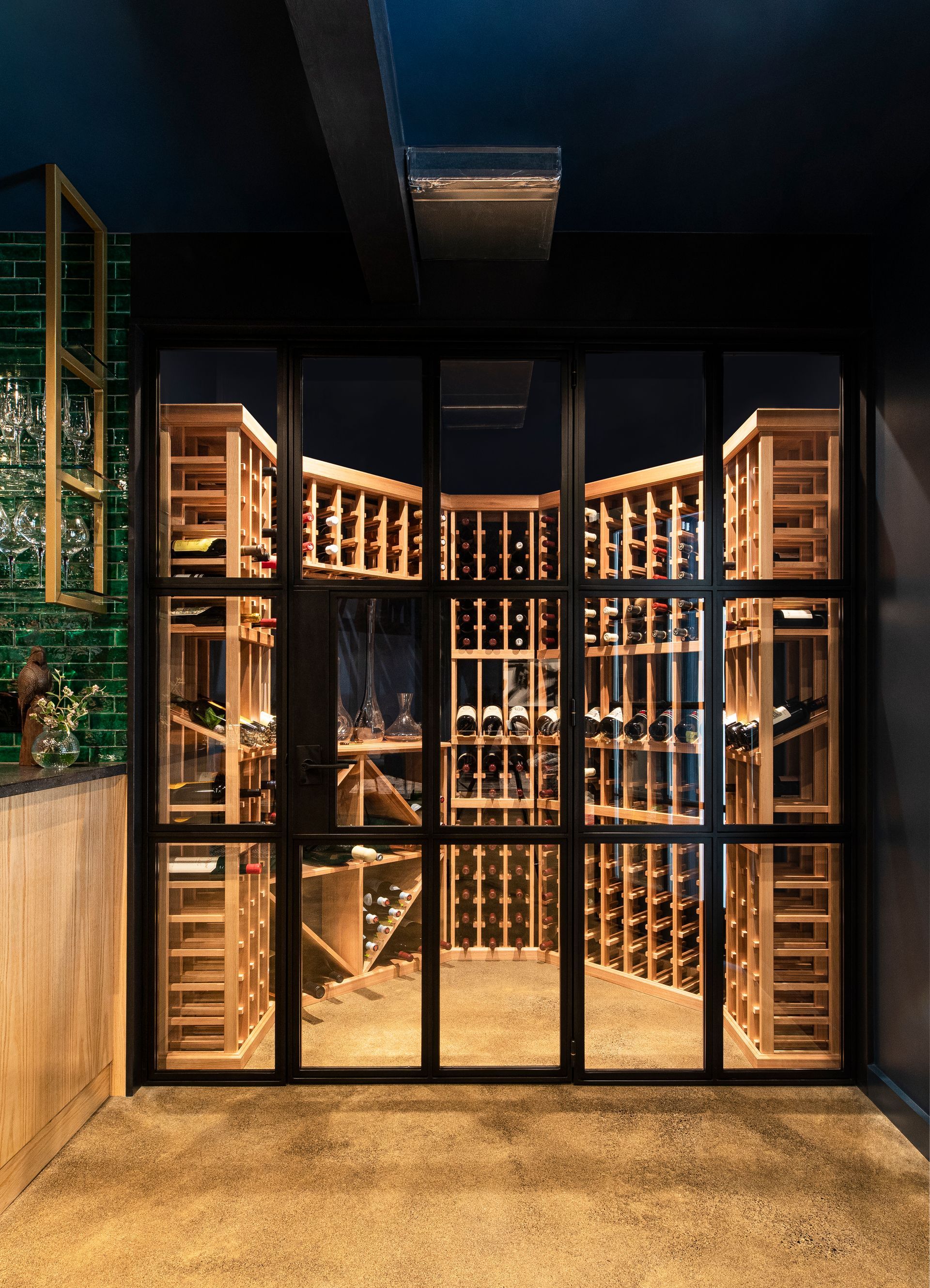 Custom basement wine room with glass doors.