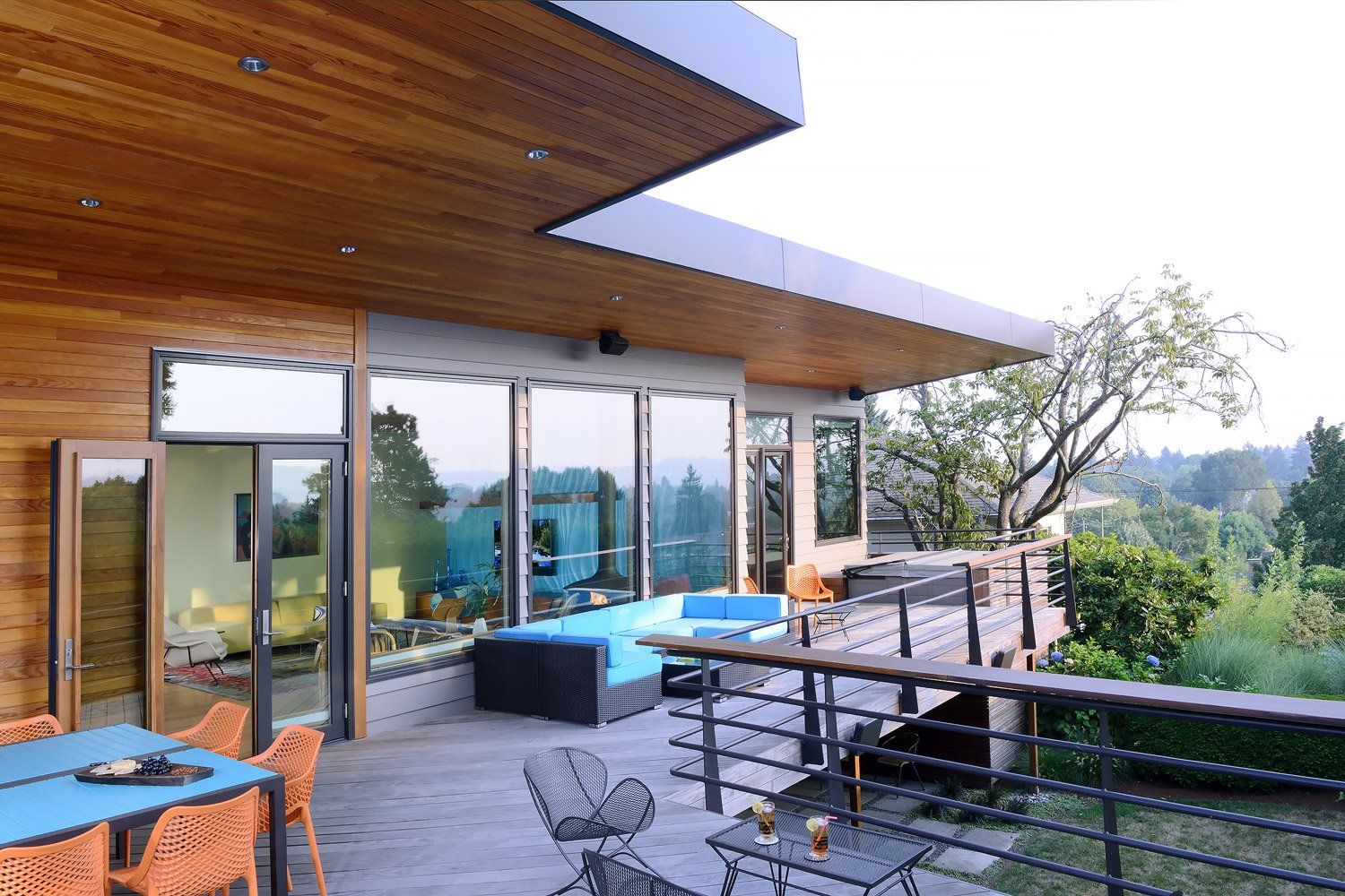 View of the rear deck and sculptural edge of the new roof structure for protection from the elements.