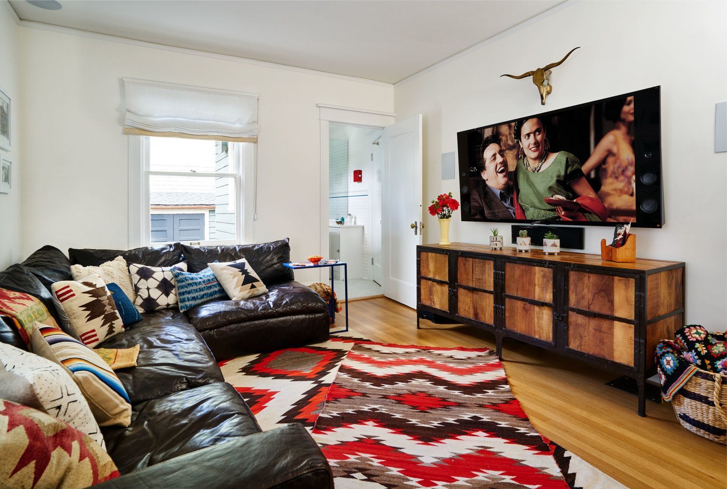 The tv room is conveniently located between the library and the kitchen.