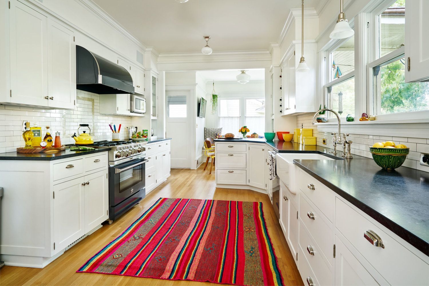Looking through the kitchen toward the roomy nook, with windows to the side and back of the house.