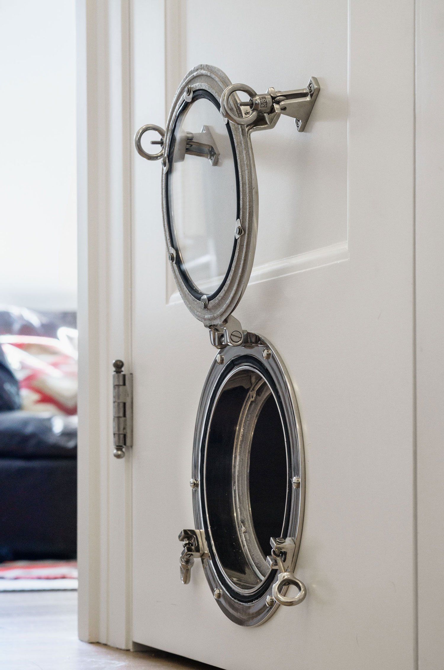 A porthole in the bottom rail of the kitchen door serves as a cat door.