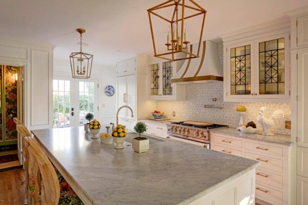 A kitchen with a large island and a stove.