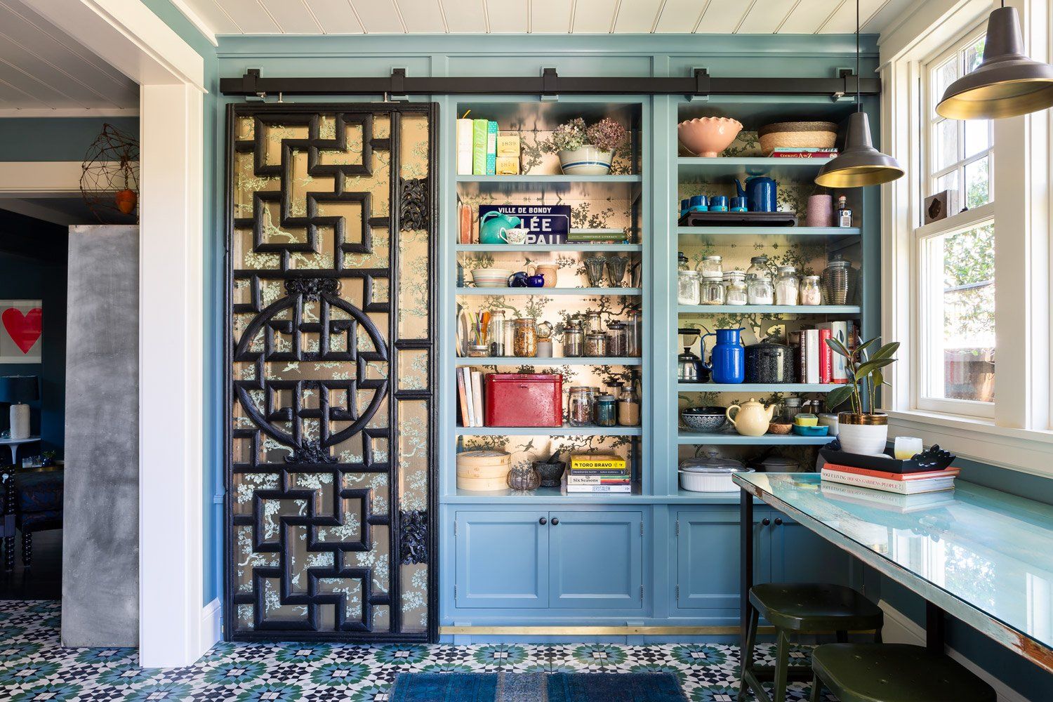 Our clients Chinese screen was repurposed as a gliding door for the built-in pantry shelves with gilded wallpaper at the back wall.