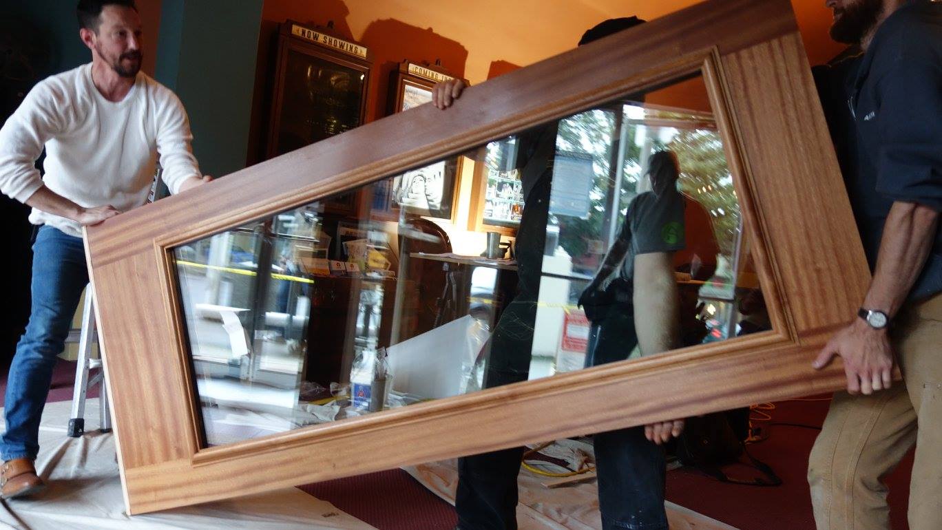 The Arciform crew installs our custom mahogany entry system