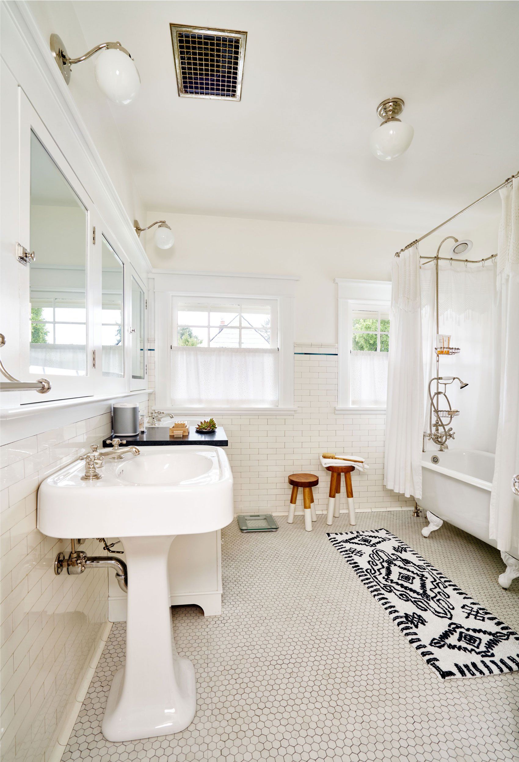 In the second floor bath, we added a second sink, storage and new lights.