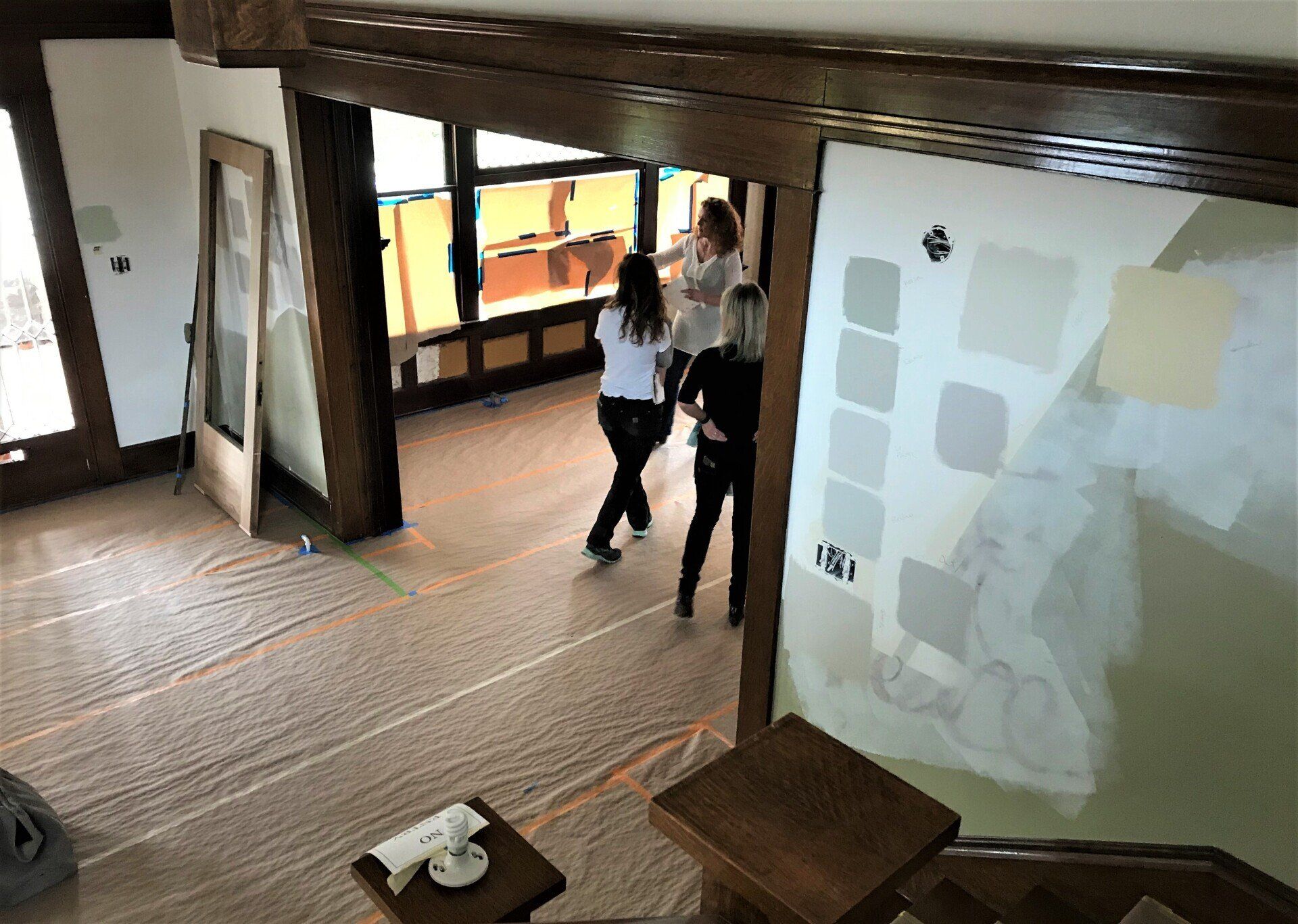 Anne De Wolf consulting with the client on tile, furnishings, fixtures, fittings, wallpaper options and rich, lush colors throughout the house.