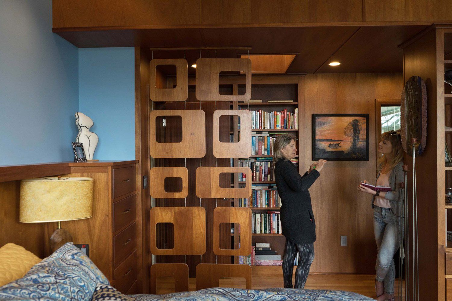 Between the main bedroom and paneled ante room is a custom geometric wooden screen.