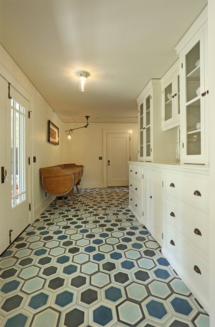 Looking from the kitchen through the new breezeway with a salvaged buffet cabinet toward the door to the garage.
