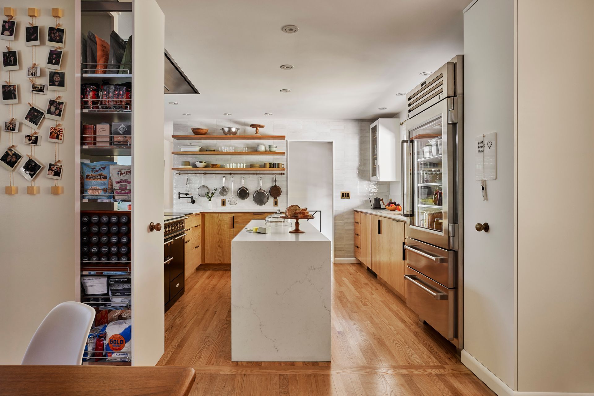 Between the dining room and open kitchen are two full-height, pullout pantry cabinets. 