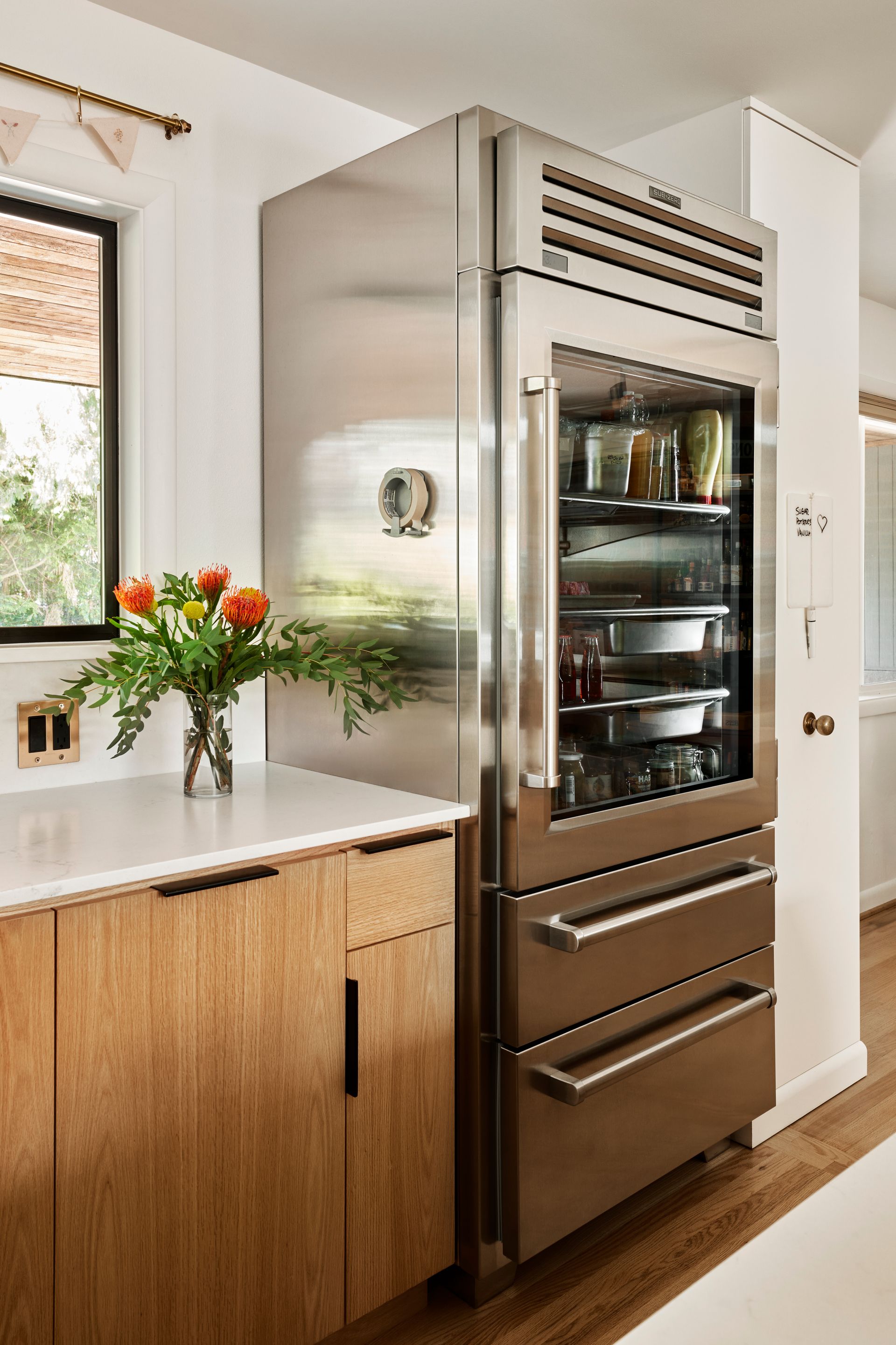 To the right of the front window is a commercial style, full height refrigerator.